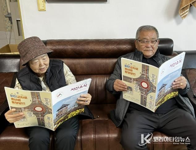 경로당에서 어르신이 큰 글자 서산소식을 읽는 모습